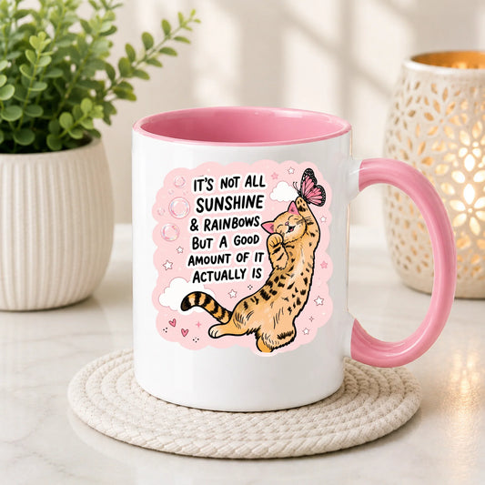White coffee mug with pink interior and handle, featuring a cute cat illustration and quote.